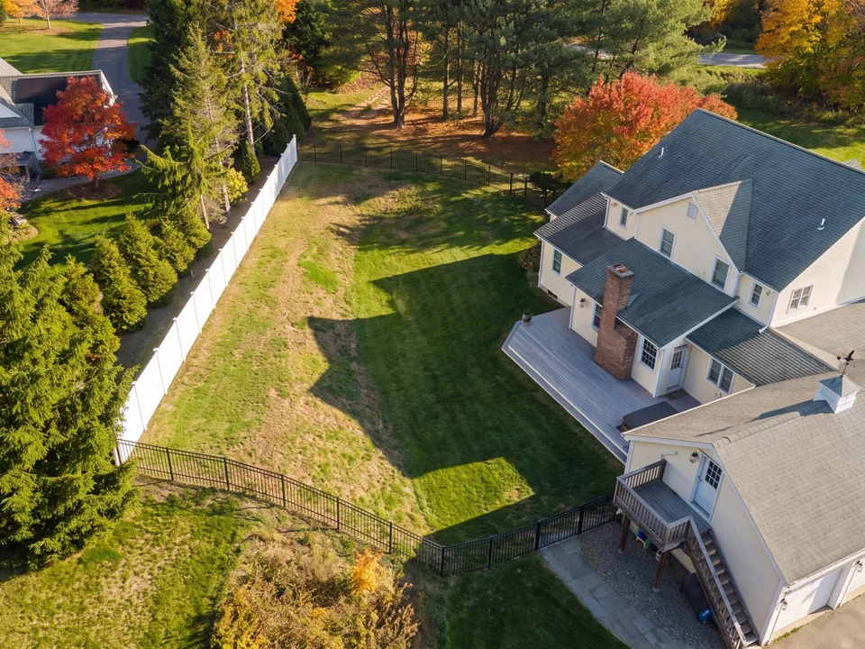 Aerial — rough fenced back lawn behind the house, empty before construction — Exterior Services LLC, Newtown, CT