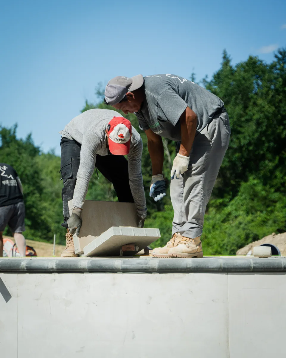 Two masons lifting a coping stone — Exterior Services LLC, Stormville, NY