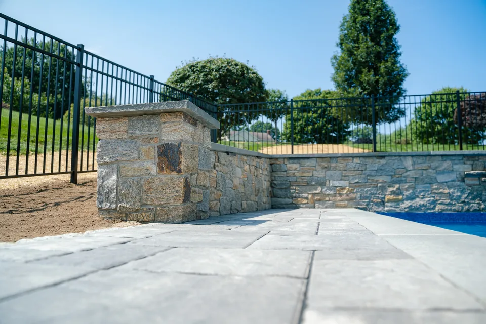 Aluminum pool fence with stone pillar — Exterior Services LLC, New Milford