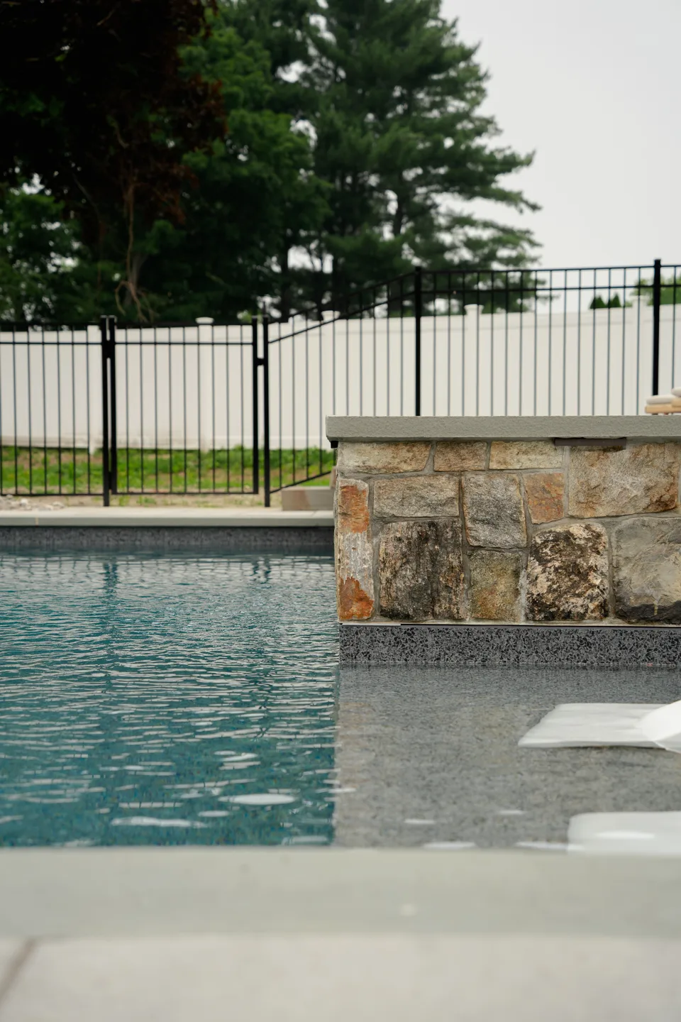 Pool corner, stone veneer pillar and vinyl fence — Exterior Services LLC, Brookfield, CT