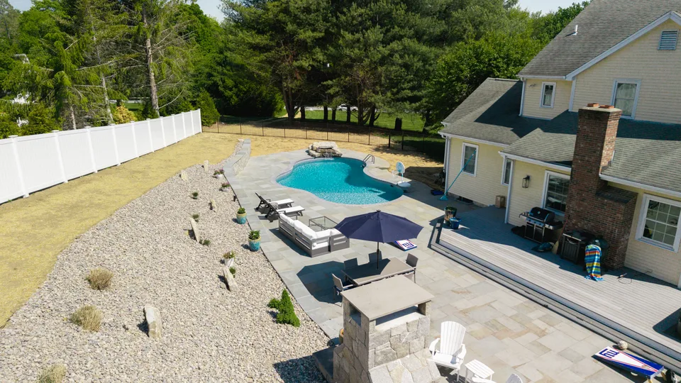 Aerial &mdash; bluestone pool terrace, planting slope and seating &mdash; Exterior Services LLC, Newtown, CT