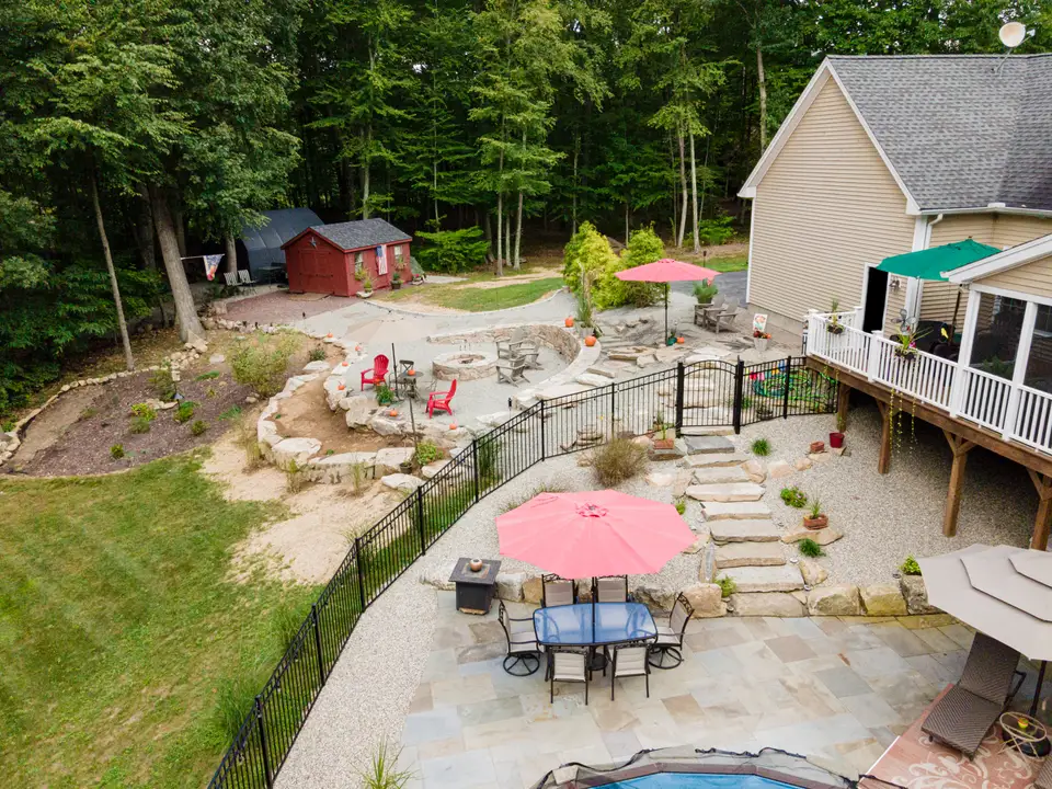 Elevated view over the boulder patio and fire area — Exterior Services LLC