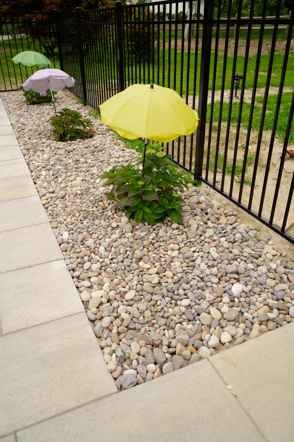 River-rock bed and planting along the paver deck — Exterior Services LLC, Brookfield, CT