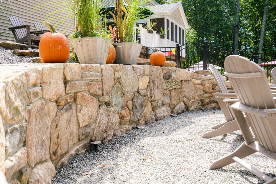 Boulder retaining wall with seating above — Exterior Services LLC
