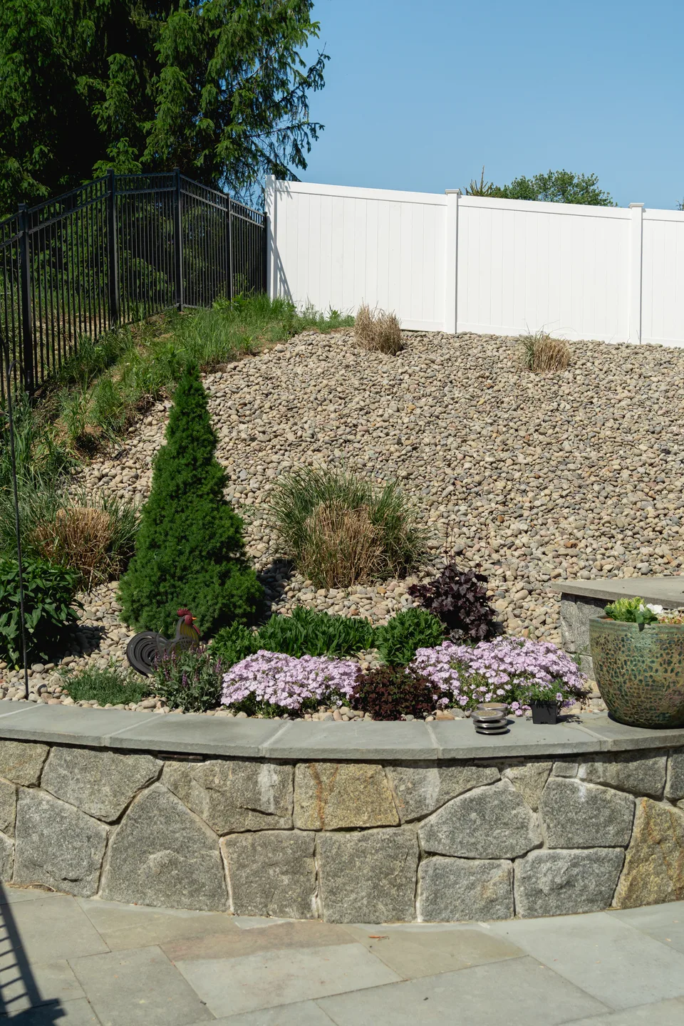 Curved fieldstone seat wall with phlox in bloom — Exterior Services LLC, Newtown, CT