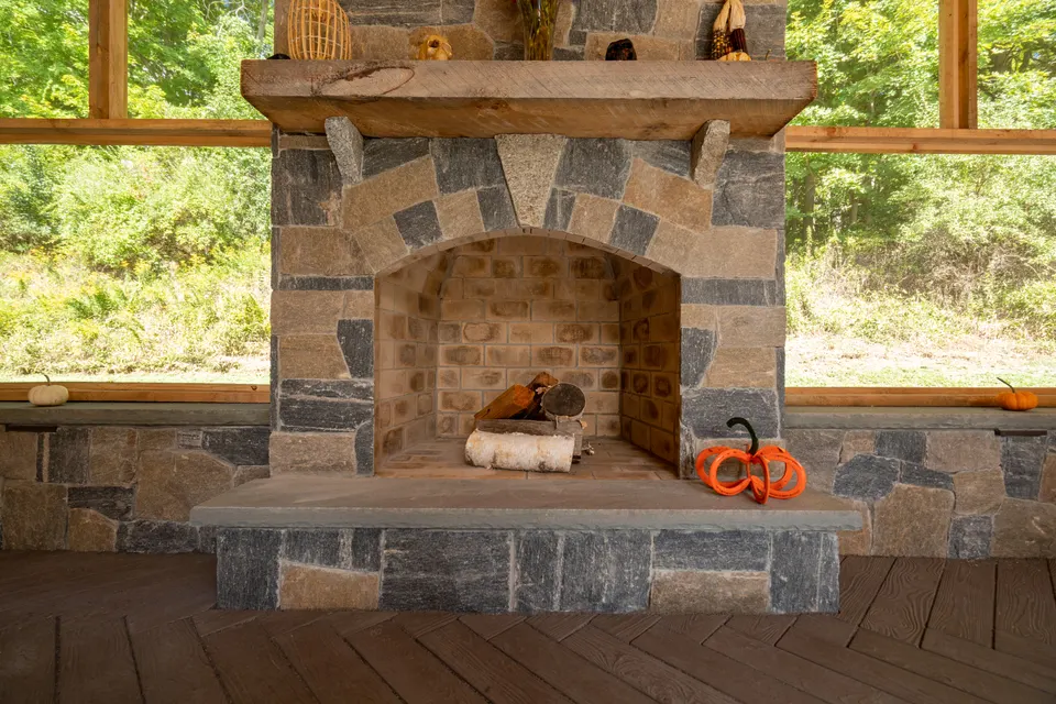Outdoor stone fireplace with timber mantel — Exterior Services LLC, Danbury, CT