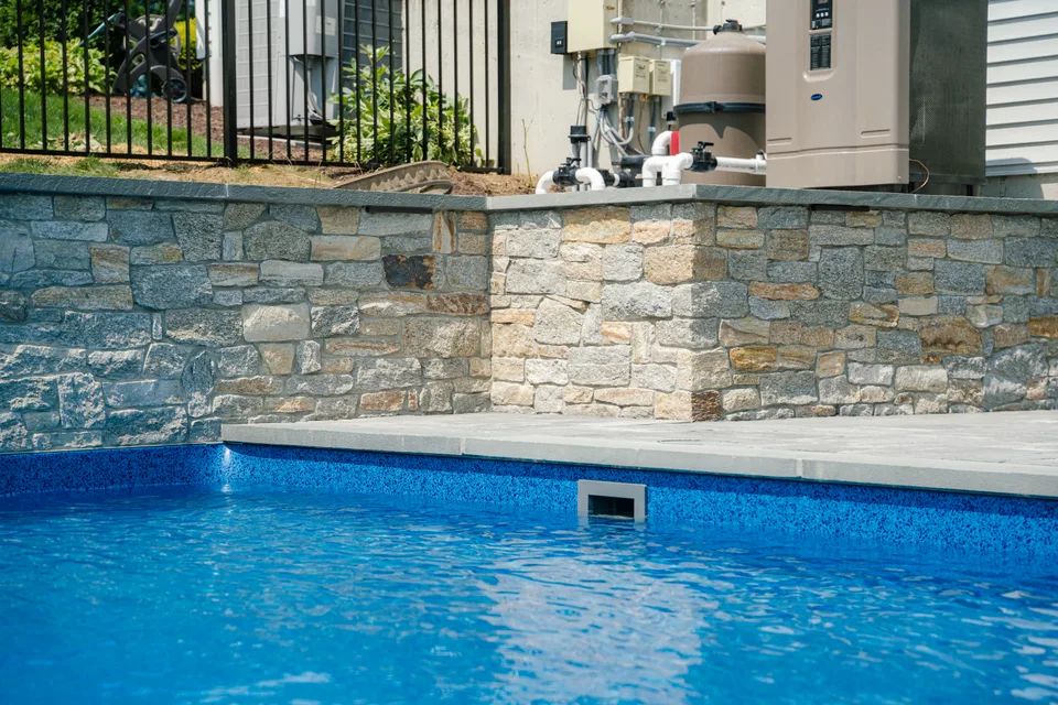 Stone veneer wall above the pool — Exterior Services LLC, New Milford