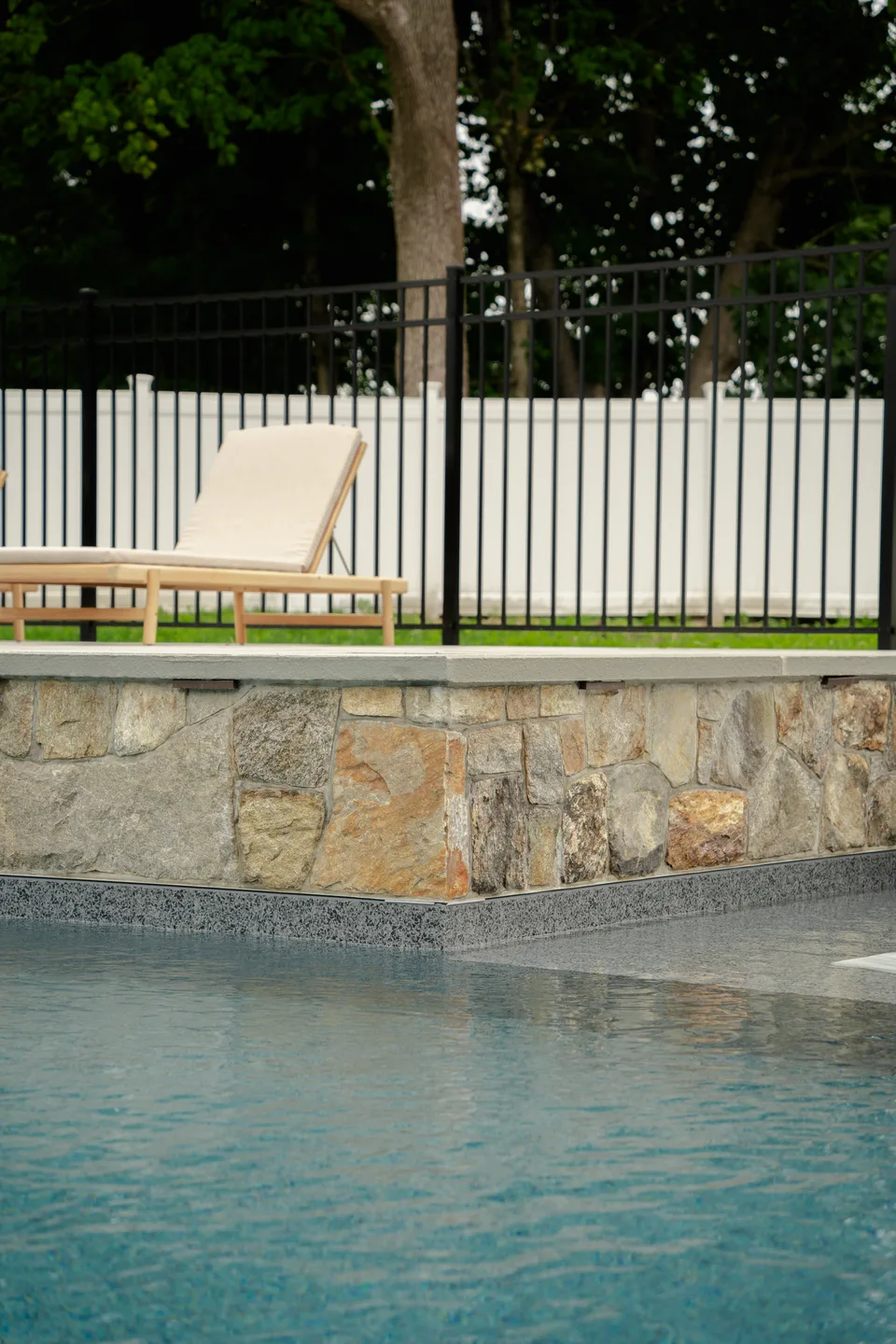 Stone veneer wall meeting the water — Exterior Services LLC, Brookfield, CT