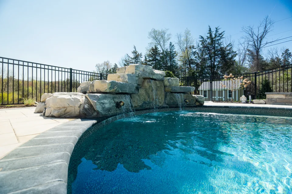 Boulder waterfall spilling into the pool — Exterior Services LLC, Stormville, NY