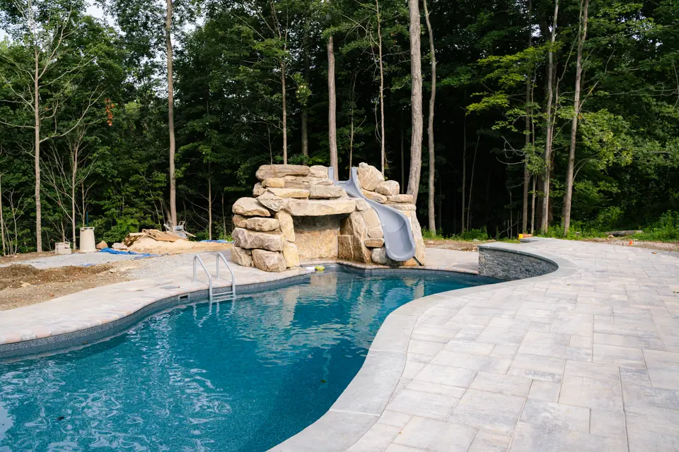 Freeform pool, boulder waterfall and slide, stamped deck — Exterior Services LLC, Carmel