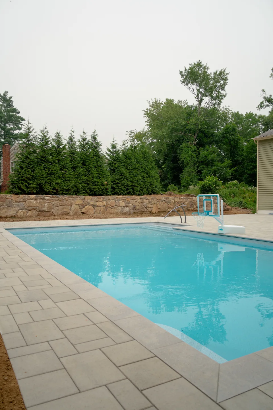 Pool and deck against the arborvitae screen — Exterior Services LLC, Danbury, CT
