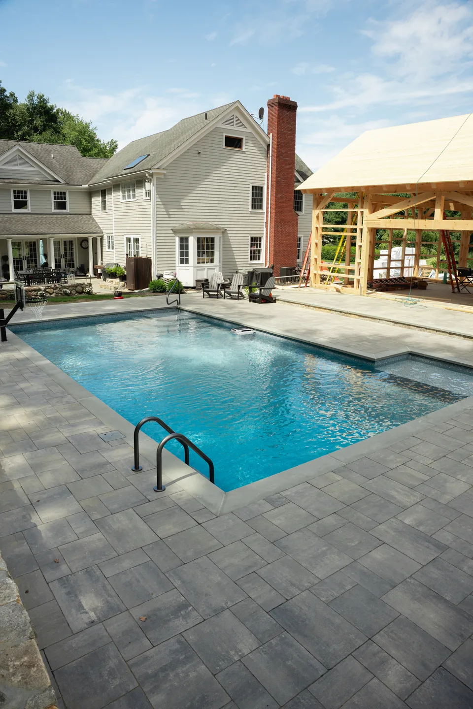 Pool filled, the pool-house frame behind — Exterior Services LLC, Bethel, CT