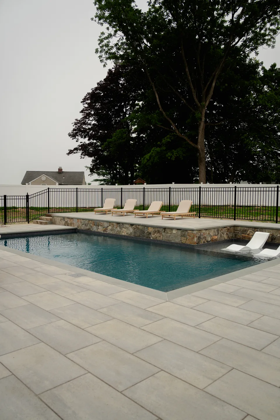 The full pool geometry from the deck corner — Exterior Services LLC, Brookfield, CT