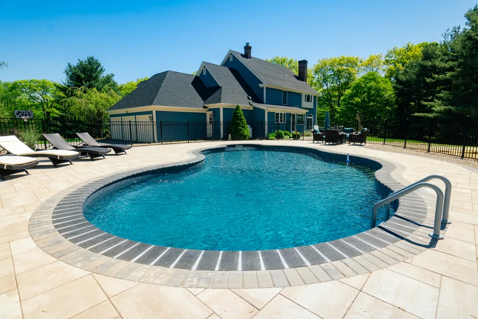 Pool with the house behind it — Exterior Services LLC
