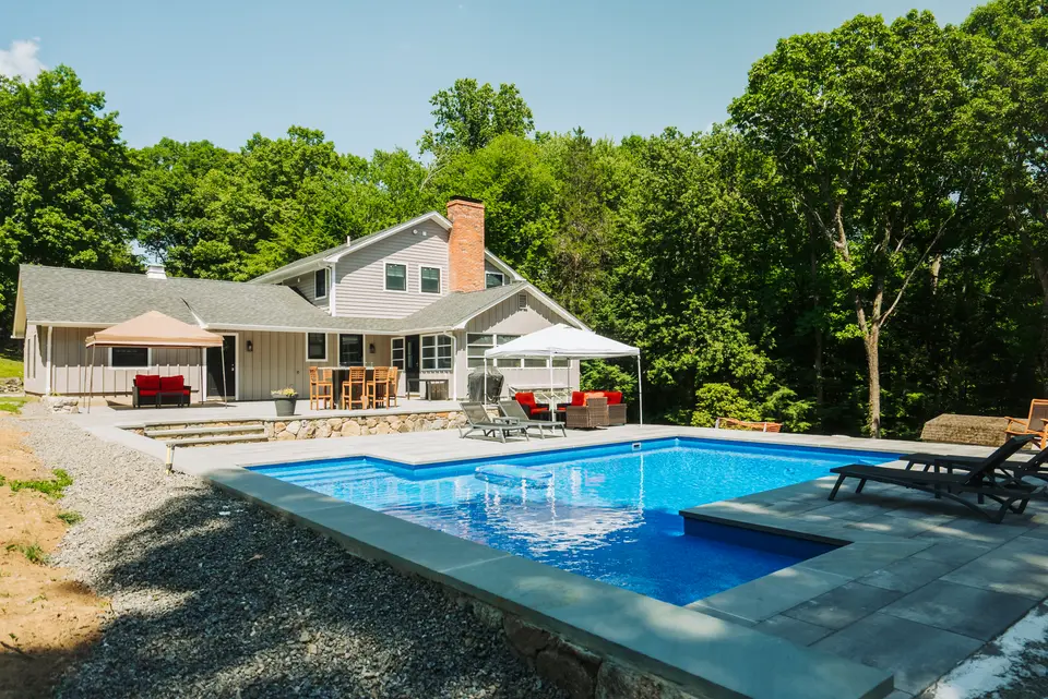 Pool and house, wide — deep blue water, strong light — Exterior Services LLC, Danbury, CT