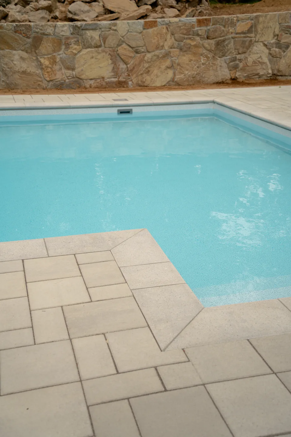 Pool and paver deck below the fieldstone wall — Exterior Services LLC, Danbury, CT