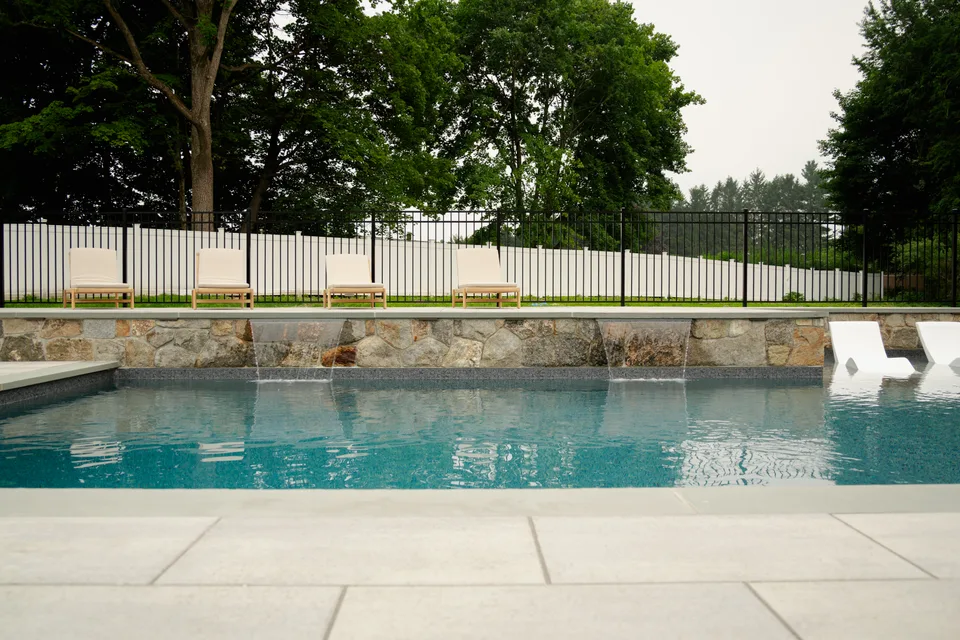 Stone veneer wall with four scuppers spilling into the pool — Exterior Services LLC, Brookfield, CT