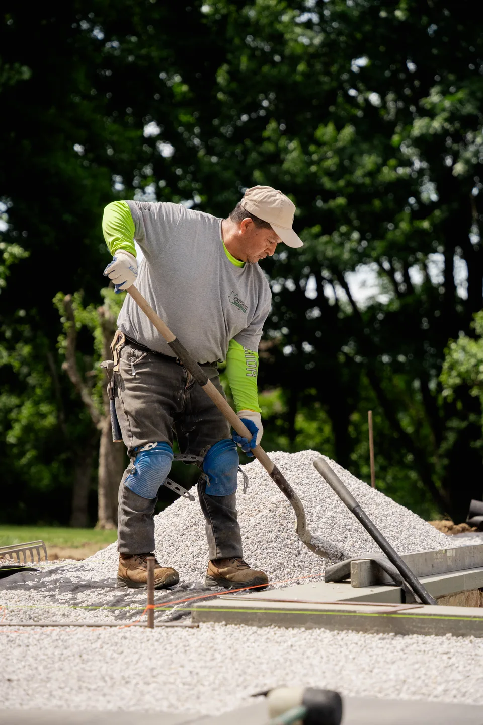 Crew member shovelling base stone on the pool deck — Exterior Services LLC, Brookfield, CT